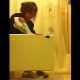 A girl is video-recorded as she poops while sitting on a toilet. She hides from view by opening the bathroom cabinet and drawers, but an audible plop can be heard. About 3 minutes.